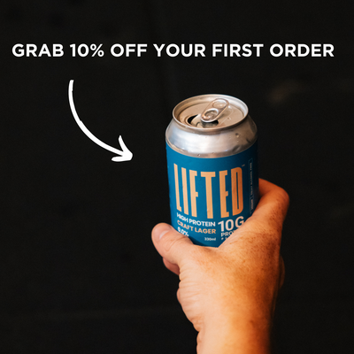 Hand holding a can of 'Lifted' protein lager with promotional text on a black background